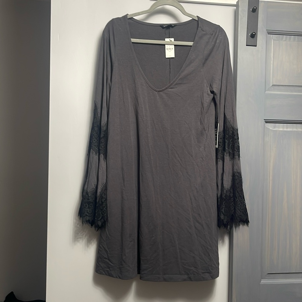 New with tags! Slate gray color dress with bell sleeves and black lace detail.